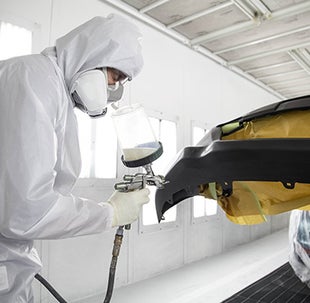 Collision Center Technician Painting a Vehicle | Brownsville Toyota in Brownsville TX
