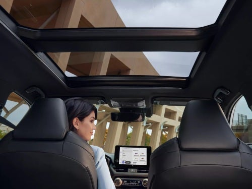 2025 Toyota RAV4 interior view looking up at the panoramic glass roof